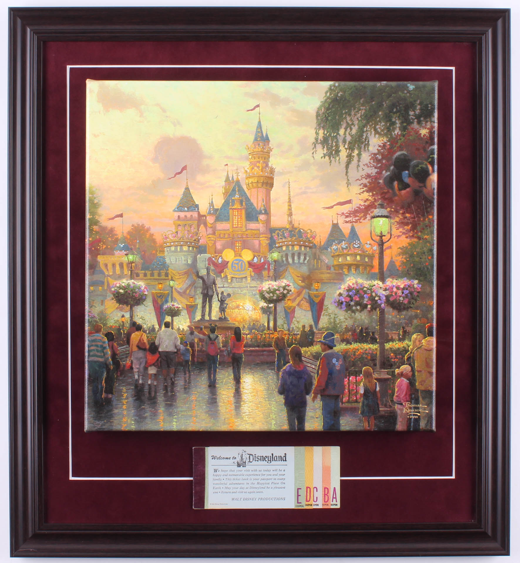 Thomas Kinkade 50th Anniversary "Disneyland" 20.5x22.5 Custom Framed Canvas on Wood Display with Full Vintage Ticket Booklet at PristineAuction.com Thomas Kinkade 50th Anniversary "Disneyland" 20.5x22.5 Custom Framed Canvas on Wood Display with Full Vintage Ticket Booklet at PristineAuction.com