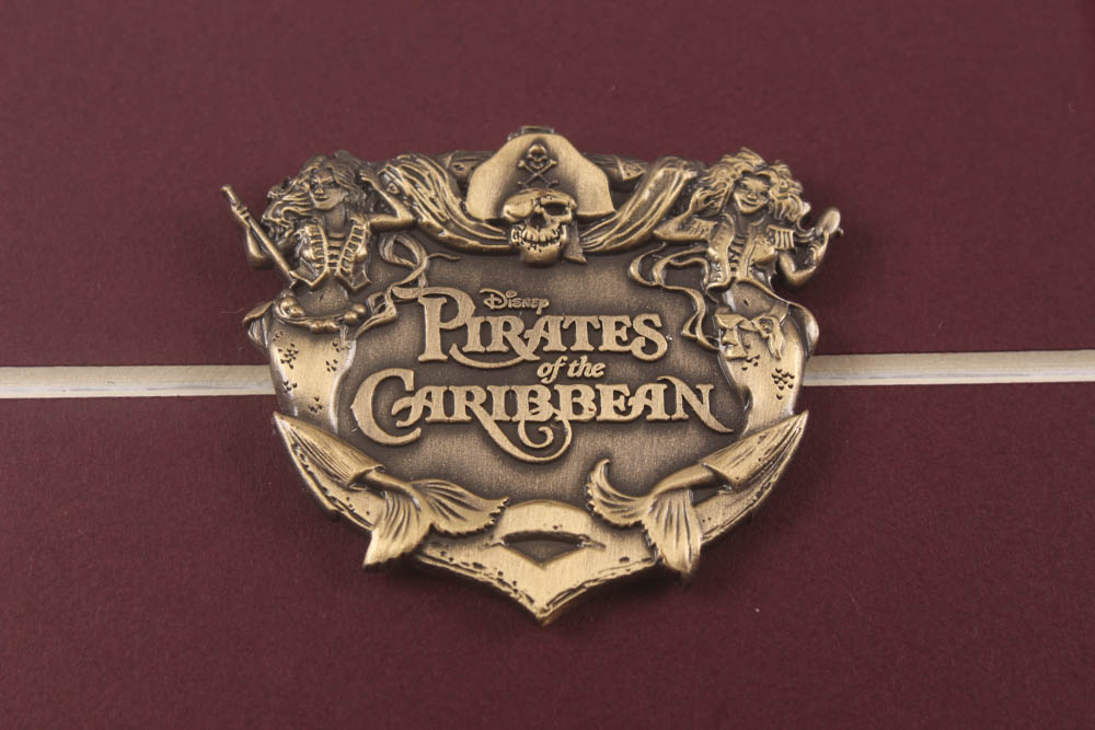 Walt Disney's "Pirates of the Caribbean" 17x26 Custom Framed Print Display with Ticket & Pirates of the Caribbean Pin at PristineAuction.com Walt Disney's "Pirates of the Caribbean" 17x26 Custom Framed Print Display with Ticket & Pirates of the Caribbean Pin at PristineAuction.com