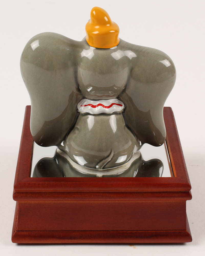 Vintage 1970's "Dumbo" Ceramic Figurine With Wood Base at PristineAuction.com Vintage 1970's "Dumbo" Ceramic Figurine With Wood Base at PristineAuction.com
