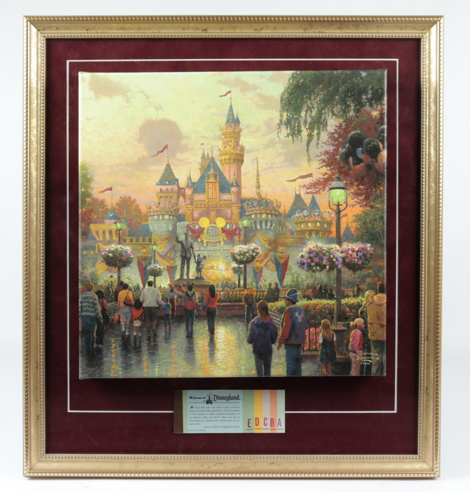 Thomas Kinkade 50th Anniversary "Disneyland" 20.5x22.5 Custom Framed Canvas on Wood Display with Vintage Ticket Booklet at PristineAuction.com Thomas Kinkade 50th Anniversary "Disneyland" 20.5x22.5 Custom Framed Canvas on Wood Display with Vintage Ticket Booklet at PristineAuction.com