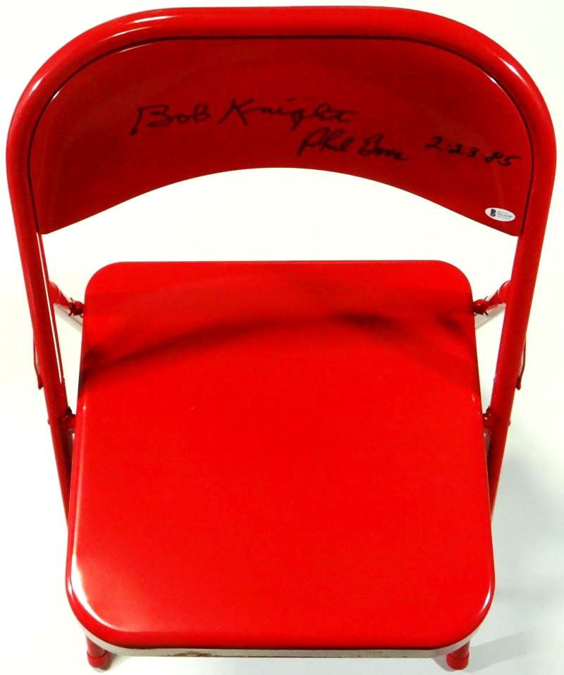 Bobby Knight & Phil Bova Signed Red Metal Folding Chair Inscribed "2-23-85" (Beckett Hologram) at PristineAuction.com Bobby Knight & Phil Bova Signed Red Metal Folding Chair Inscribed "2-23-85" (Beckett Hologram) at PristineAuction.com