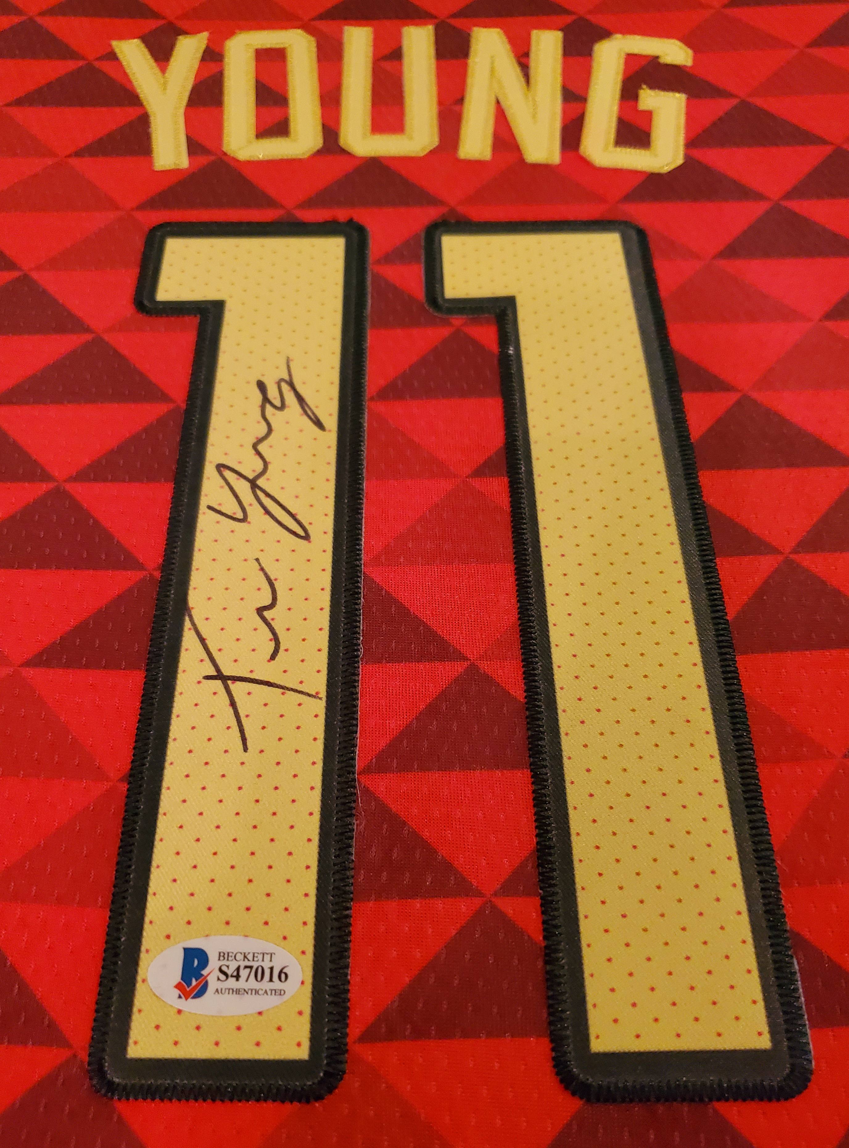 Trae Young Signed 35x43 Custom Framed Jersey Display with 2019-20 Hoops Premium Stock #1 & 2019-20 Panini Illusions #136 (Beckett LOA) at PristineAuction.com Trae Young Signed 35x43 Custom Framed Jersey Display with 2019-20 Hoops Premium Stock #1 & 2019-20 Panini Illusions #136 (Beckett LOA) at PristineAuction.com