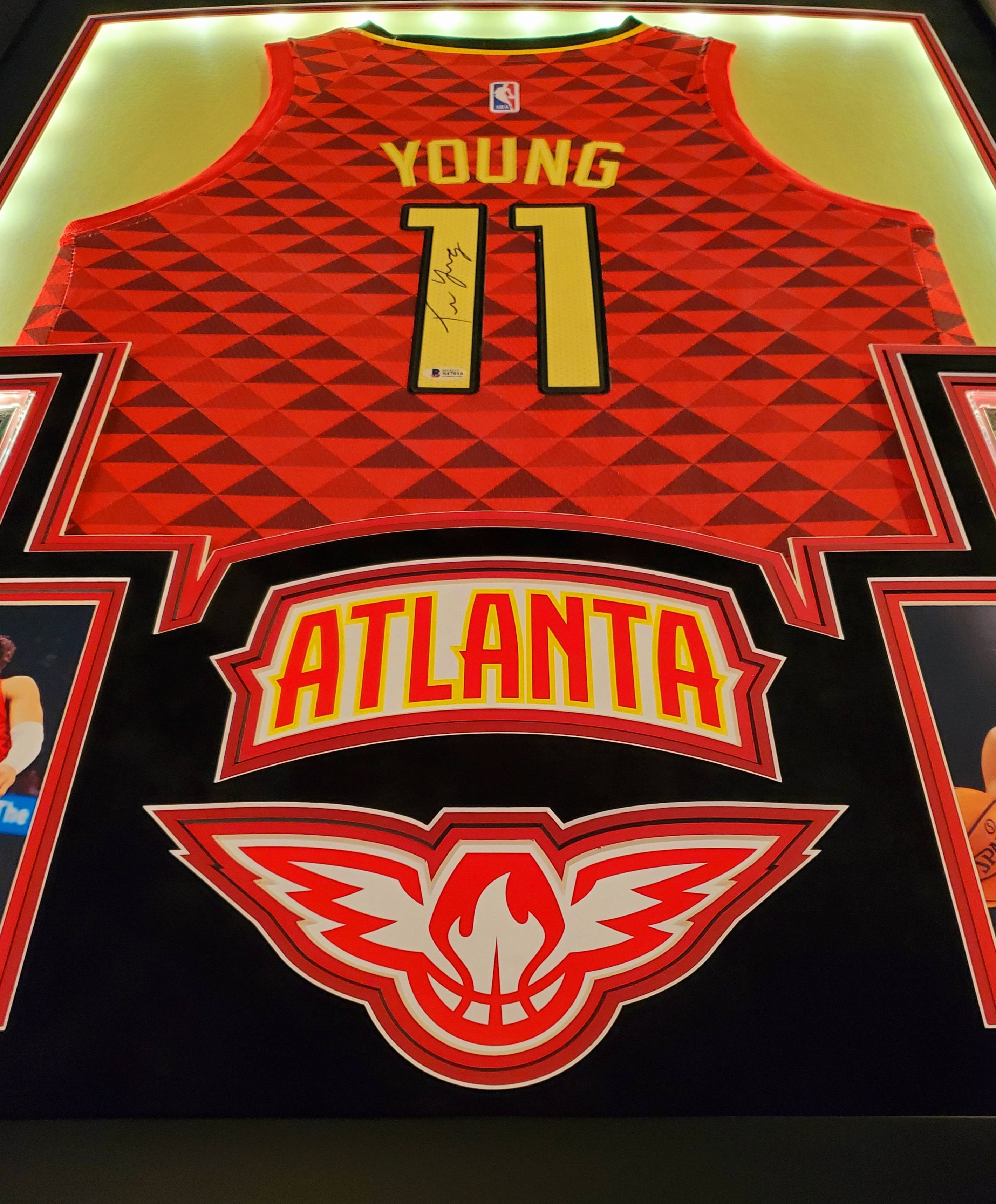 Trae Young Signed 35x43 Custom Framed Jersey Display with 2019-20 Hoops Premium Stock #1 & 2019-20 Panini Illusions #136 (Beckett LOA) at PristineAuction.com Trae Young Signed 35x43 Custom Framed Jersey Display with 2019-20 Hoops Premium Stock #1 & 2019-20 Panini Illusions #136 (Beckett LOA) at PristineAuction.com