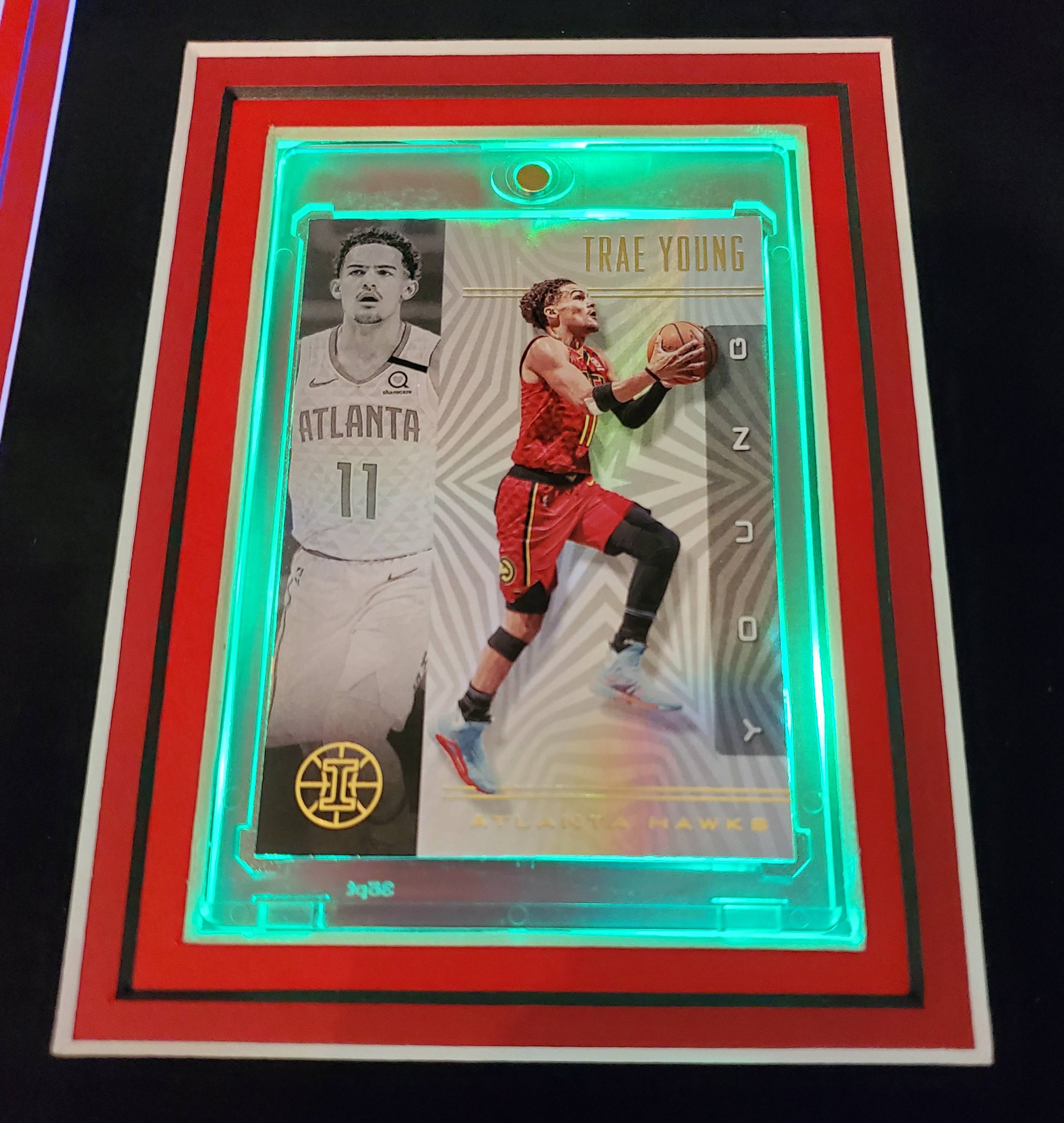 Trae Young Signed 35x43 Custom Framed Jersey Display with 2019-20 Hoops Premium Stock #1 & 2019-20 Panini Illusions #136 (Beckett LOA) at PristineAuction.com Trae Young Signed 35x43 Custom Framed Jersey Display with 2019-20 Hoops Premium Stock #1 & 2019-20 Panini Illusions #136 (Beckett LOA) at PristineAuction.com