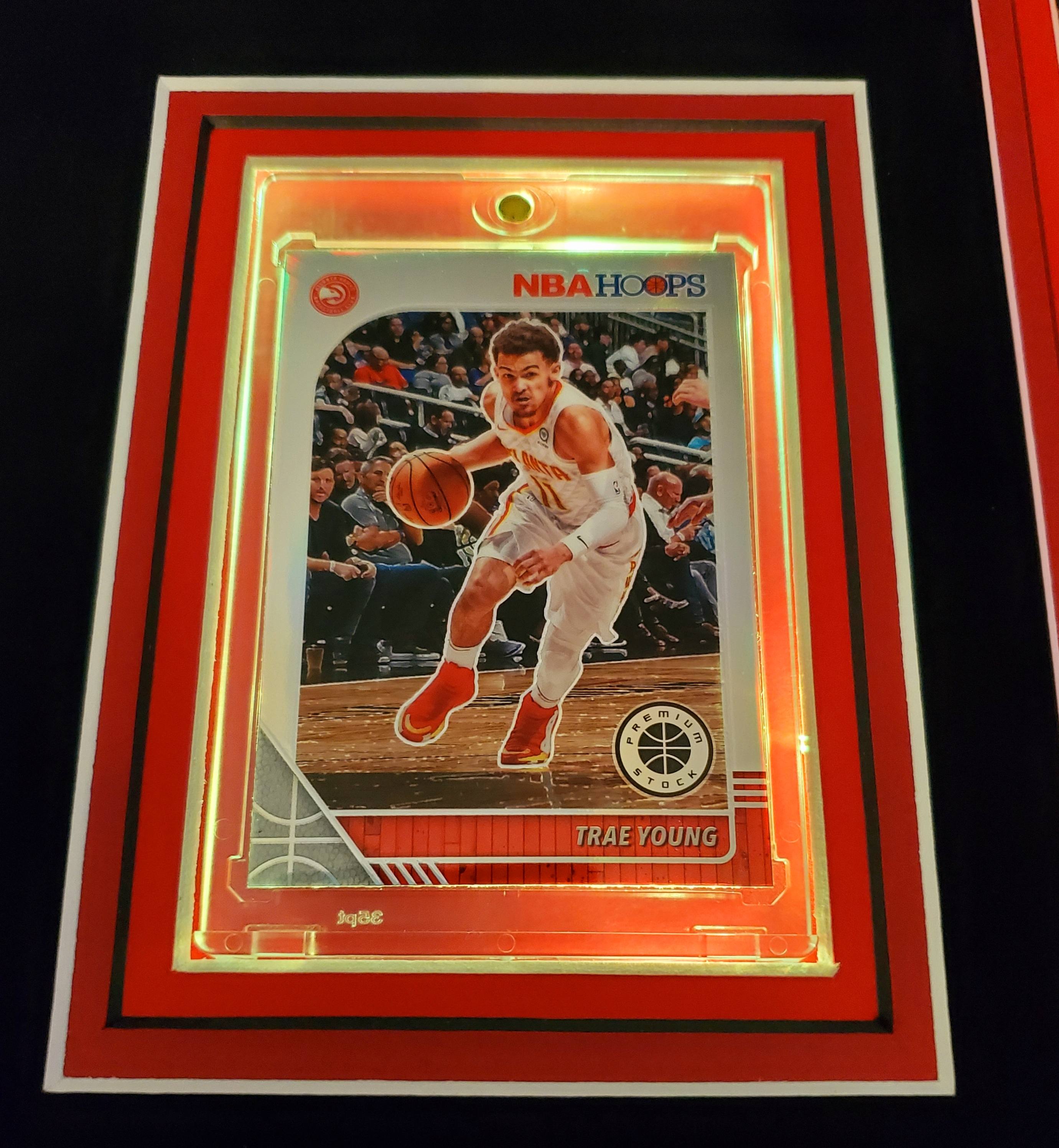 Trae Young Signed 35x43 Custom Framed Jersey Display with 2019-20 Hoops Premium Stock #1 & 2019-20 Panini Illusions #136 (Beckett LOA) at PristineAuction.com Trae Young Signed 35x43 Custom Framed Jersey Display with 2019-20 Hoops Premium Stock #1 & 2019-20 Panini Illusions #136 (Beckett LOA) at PristineAuction.com