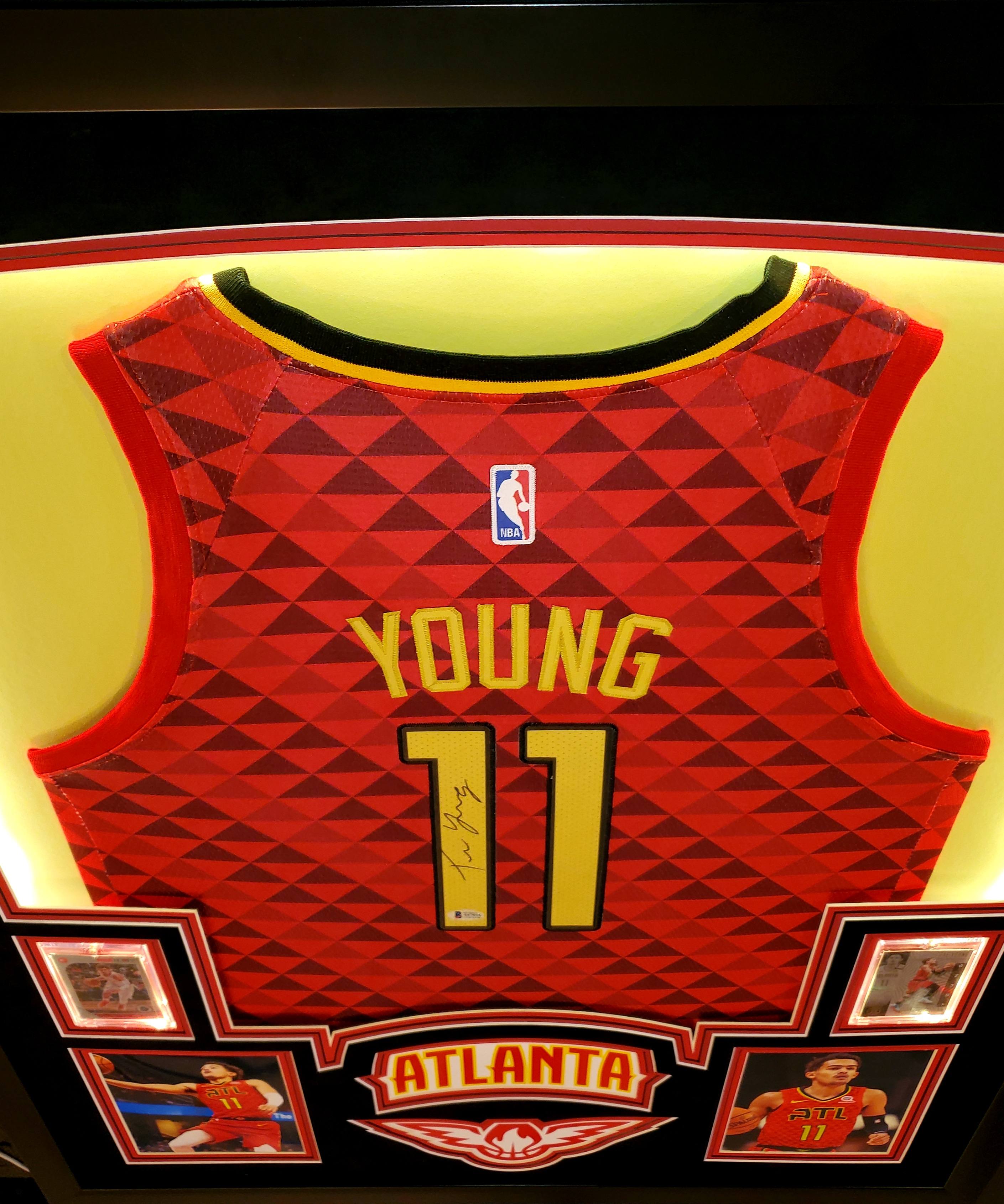 Trae Young Signed 35x43 Custom Framed Jersey Display with 2019-20 Hoops Premium Stock #1 & 2019-20 Panini Illusions #136 (Beckett LOA) at PristineAuction.com Trae Young Signed 35x43 Custom Framed Jersey Display with 2019-20 Hoops Premium Stock #1 & 2019-20 Panini Illusions #136 (Beckett LOA) at PristineAuction.com