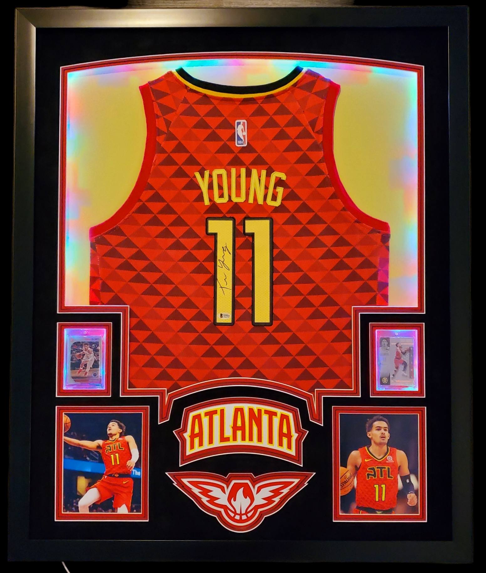 Trae Young Signed 35x43 Custom Framed Jersey Display with 2019-20 Hoops Premium Stock #1 & 2019-20 Panini Illusions #136 (Beckett LOA) at PristineAuction.com Trae Young Signed 35x43 Custom Framed Jersey Display with 2019-20 Hoops Premium Stock #1 & 2019-20 Panini Illusions #136 (Beckett LOA) at PristineAuction.com