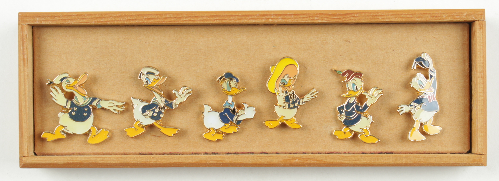 Set of (6) Vintage Walt Disney Donald Duck Pin Collection In Wood Case at PristineAuction.com Set of (6) Vintage Walt Disney Donald Duck Pin Collection In Wood Case at PristineAuction.com