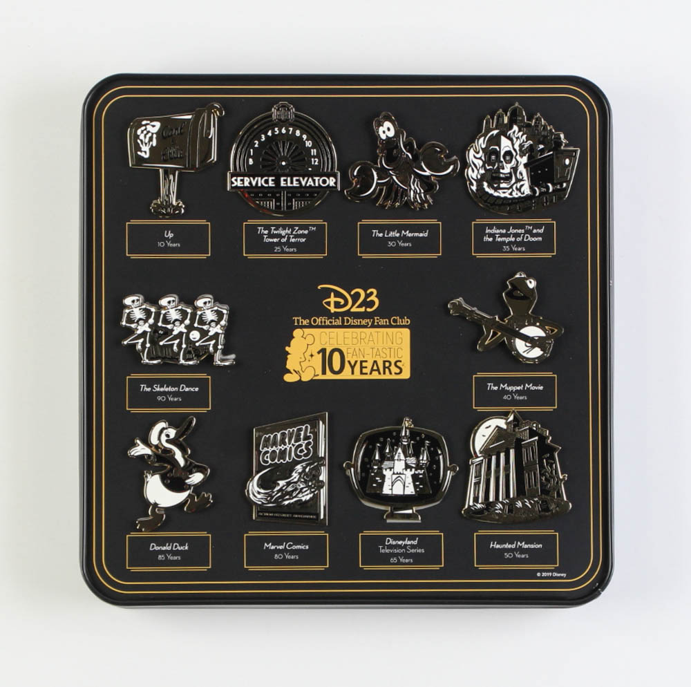 D23 The Official Disney Fan Club 10th Anniversary Complete Set of (10) Extra-Large Pins with Tin Box at PristineAuction.com D23 The Official Disney Fan Club 10th Anniversary Complete Set of (10) Extra-Large Pins with Tin Box at PristineAuction.com