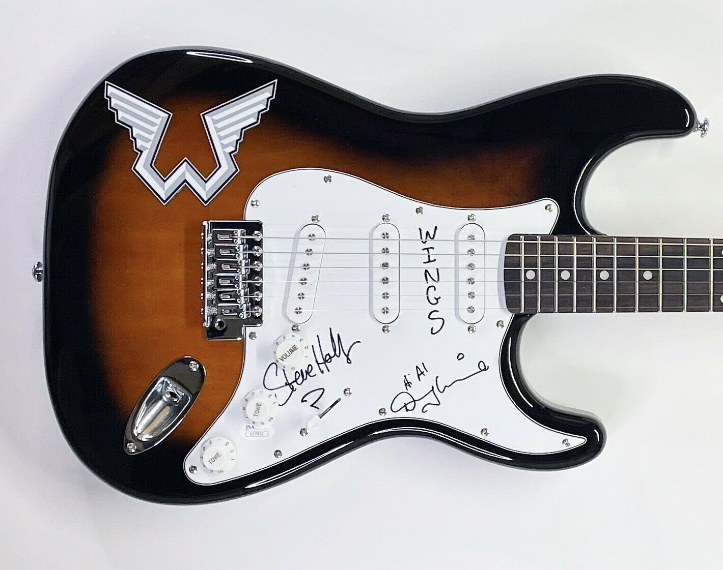 Denny Laine & Steve Holley Signed Wings Logo Electric Guitar Inscribed "Wings" (JSA) at PristineAuction.com Denny Laine & Steve Holley Signed Wings Logo Electric Guitar Inscribed "Wings" (JSA) at PristineAuction.com