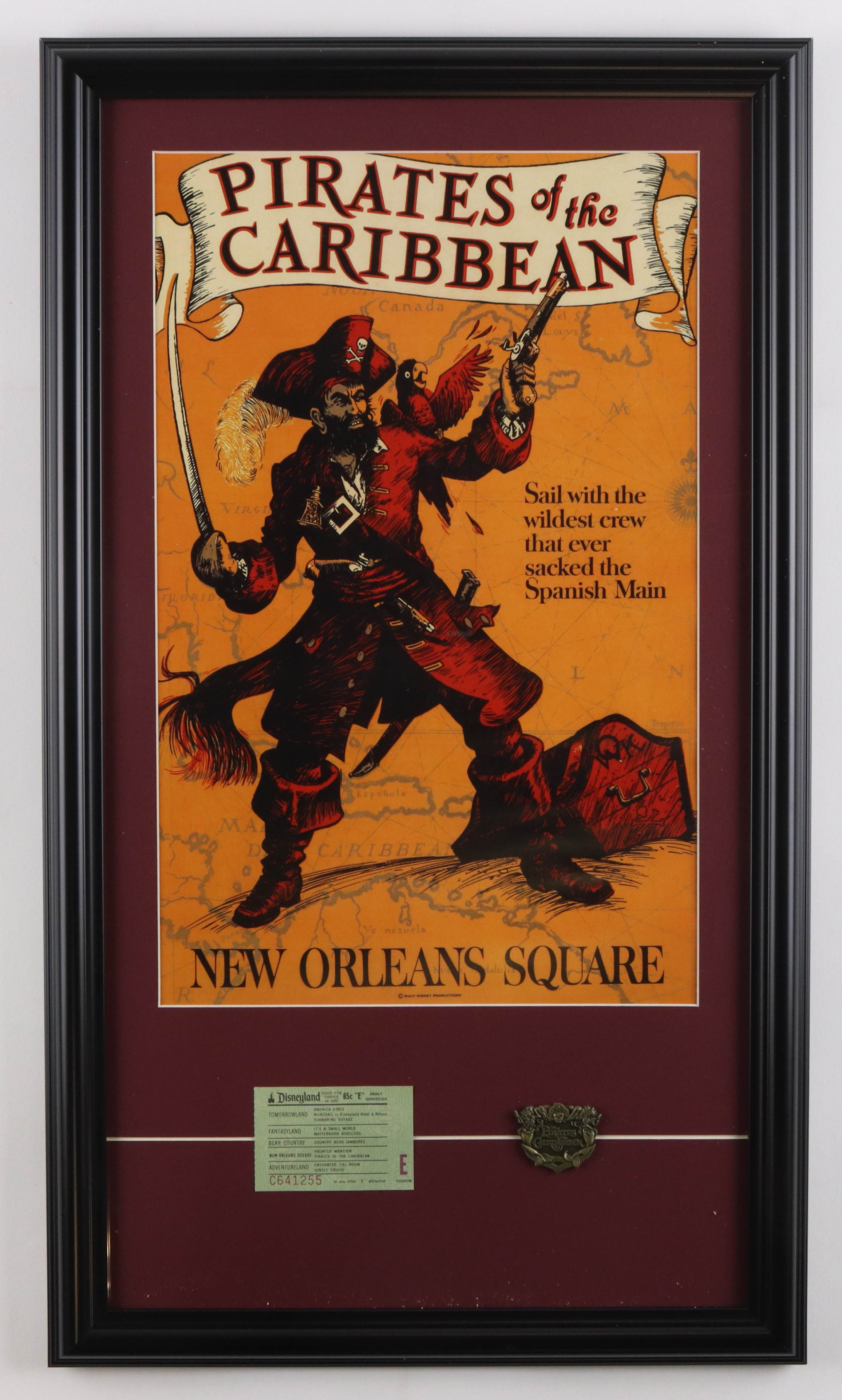 Disneyland "Pirates of the Caribbean" Custom Framed Poster Print Display with Vintage Disneyland 'E' Ticket & Brass Official Ride Emblem at PristineAuction.com Disneyland "Pirates of the Caribbean" Custom Framed Poster Print Display with Vintage Disneyland 'E' Ticket & Brass Official Ride Emblem at PristineAuction.com