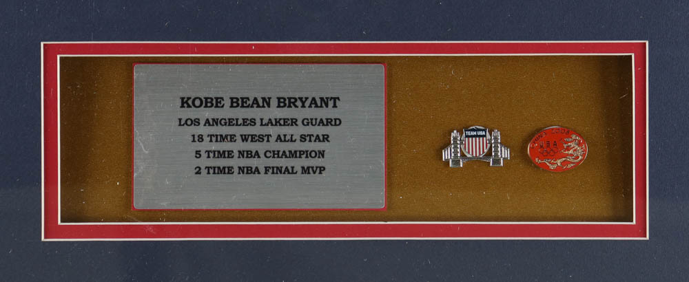 Kobe Bryant Custom Framed Team USA Jersey Display with (2) Olympic Basketball Pins at PristineAuction.com Kobe Bryant Custom Framed Team USA Jersey Display with (2) Olympic Basketball Pins at PristineAuction.com