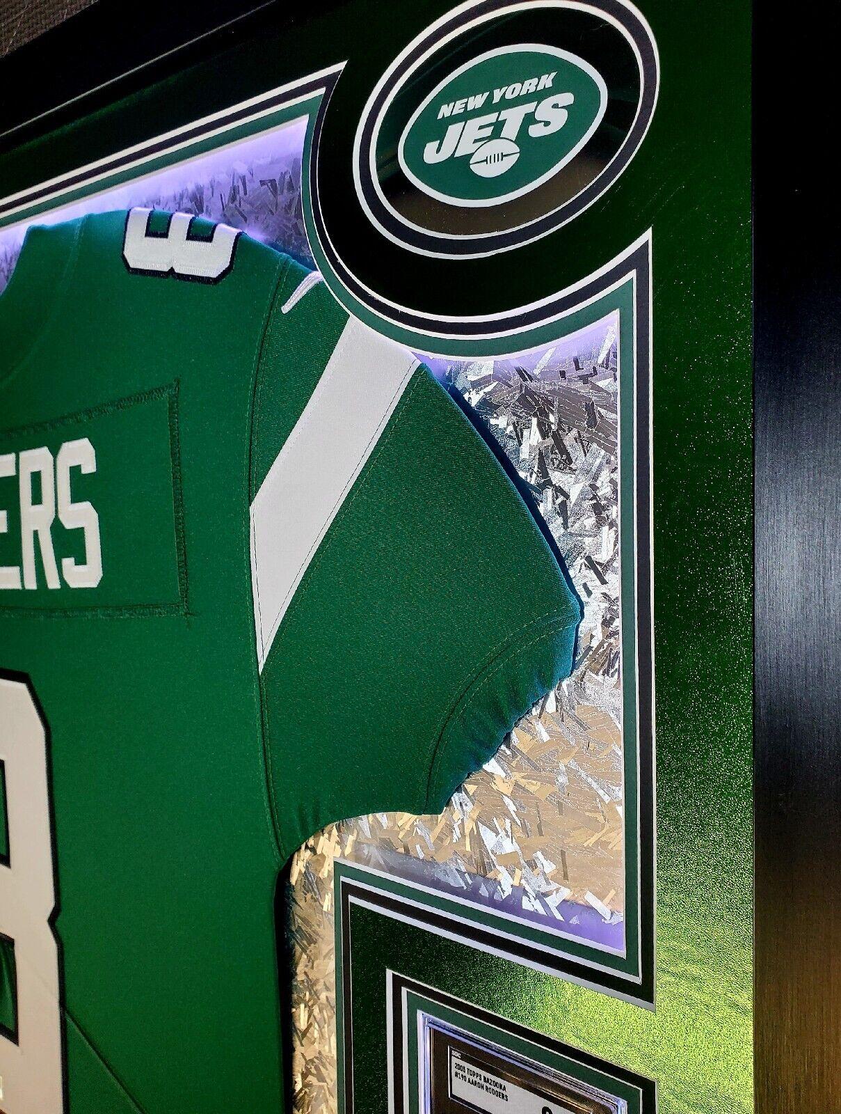 Aaron Rodgers Signed 33x42 Custom Framed Jersey Display with LED Lighting, 2005 UD Rookie Premiere #16 (RC) (SGC9.5)& 2005 Topps Bazooka #190 (RC) (SGC9.5) (Fanatics) at PristineAuction.com Aaron Rodgers Signed 33x42 Custom Framed Jersey Display with LED Lighting, 2005 UD Rookie Premiere #16 (RC) (SGC9.5)& 2005 Topps Bazooka #190 (RC) (SGC9.5) (Fanatics) at PristineAuction.com