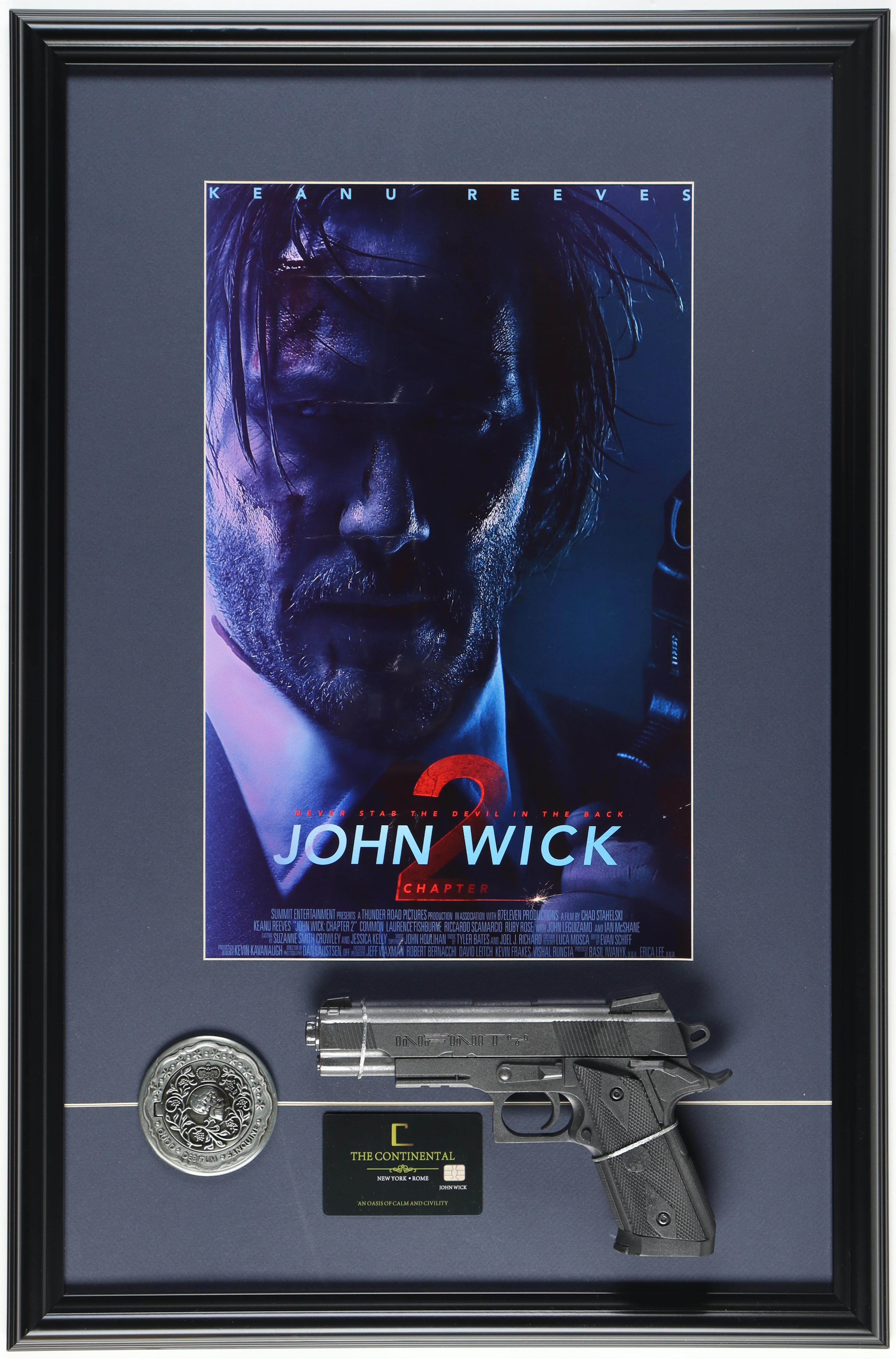 "John Wick: Chapter Two" Custom Framed Movie Poster Display with Prop Replica Pistol, Continental Key Card & Gold Coin at PristineAuction.com "John Wick: Chapter Two" Custom Framed Movie Poster Display with Prop Replica Pistol, Continental Key Card & Gold Coin at PristineAuction.com