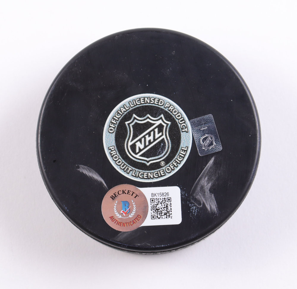 MacKenzie Weegar Signed Flames Logo Puck (Beckett) at PristineAuction.com MacKenzie Weegar Signed Flames Logo Puck (Beckett) at PristineAuction.com