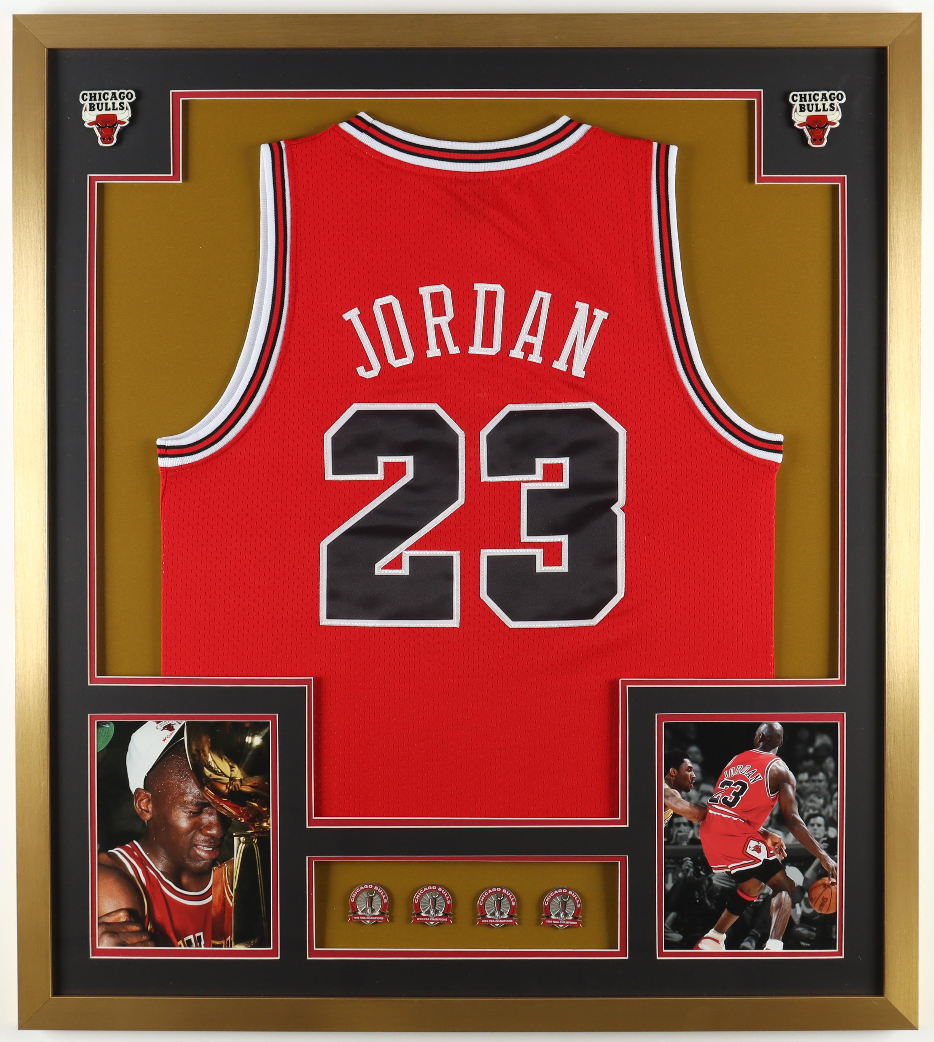 Michael Jordan Custom Framed Jersey Display With (4) LE Bulls Championship Pins & (2) Metal Team Logos at PristineAuction.com Michael Jordan Custom Framed Jersey Display With (4) LE Bulls Championship Pins & (2) Metal Team Logos at PristineAuction.com