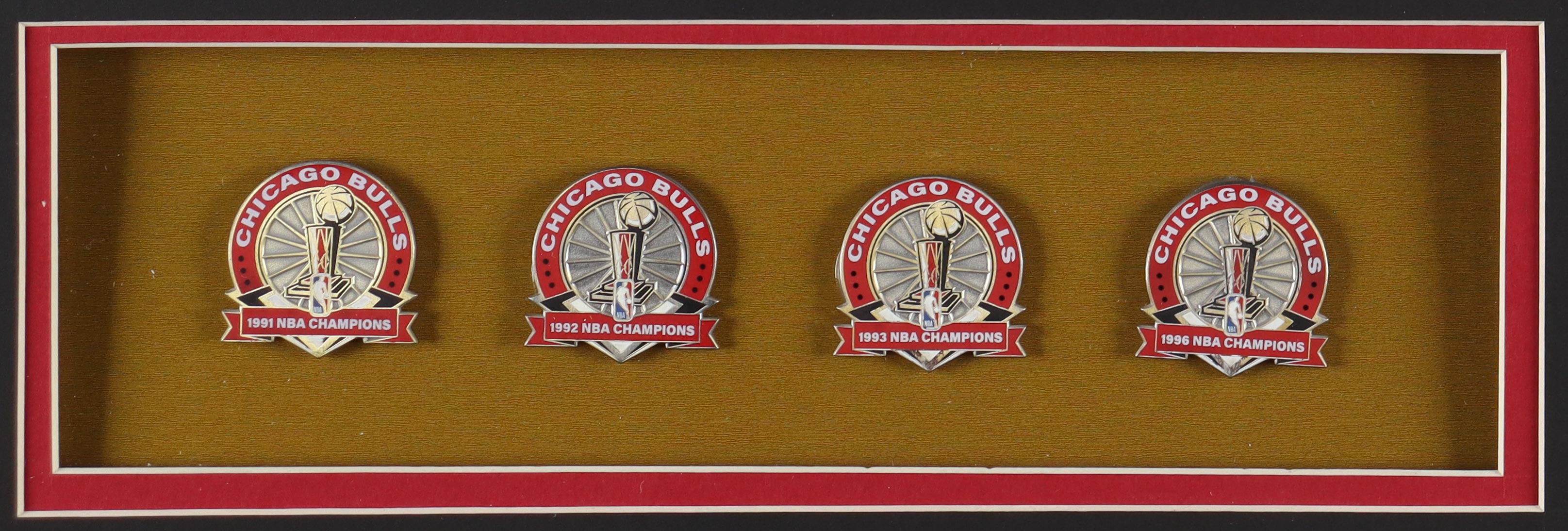 Michael Jordan Custom Framed Jersey Display With (4) LE Bulls Championship Pins & (2) Metal Team Logos at PristineAuction.com Michael Jordan Custom Framed Jersey Display With (4) LE Bulls Championship Pins & (2) Metal Team Logos at PristineAuction.com