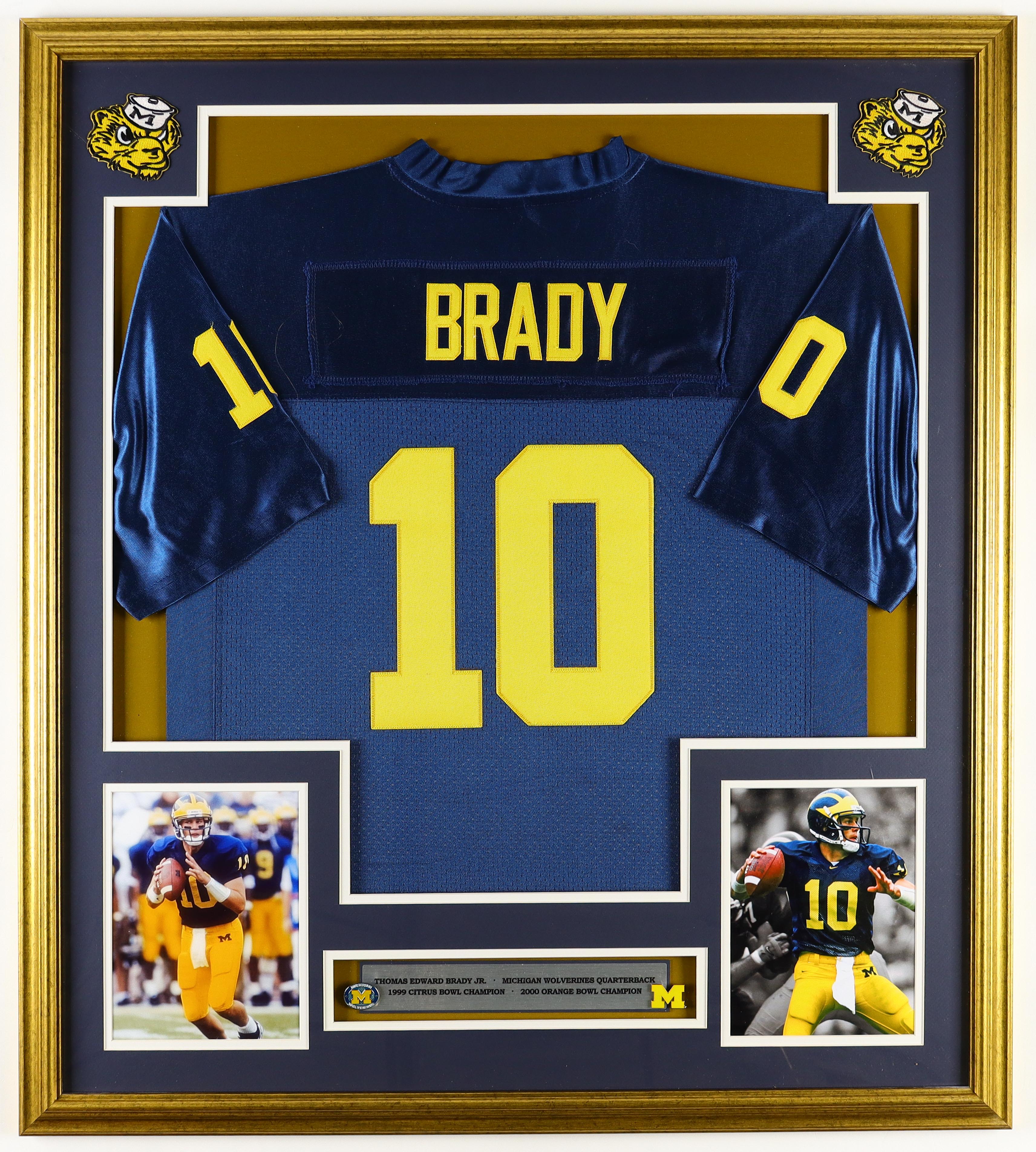Tom Brady Michigan Wolverines Custom Framed Nike Air Jordan Jersey Display With (2) Team Logo Pins & (2) Cloth Patch Emblems at PristineAuction.com Tom Brady Michigan Wolverines Custom Framed Nike Air Jordan Jersey Display With (2) Team Logo Pins & (2) Cloth Patch Emblems at PristineAuction.com