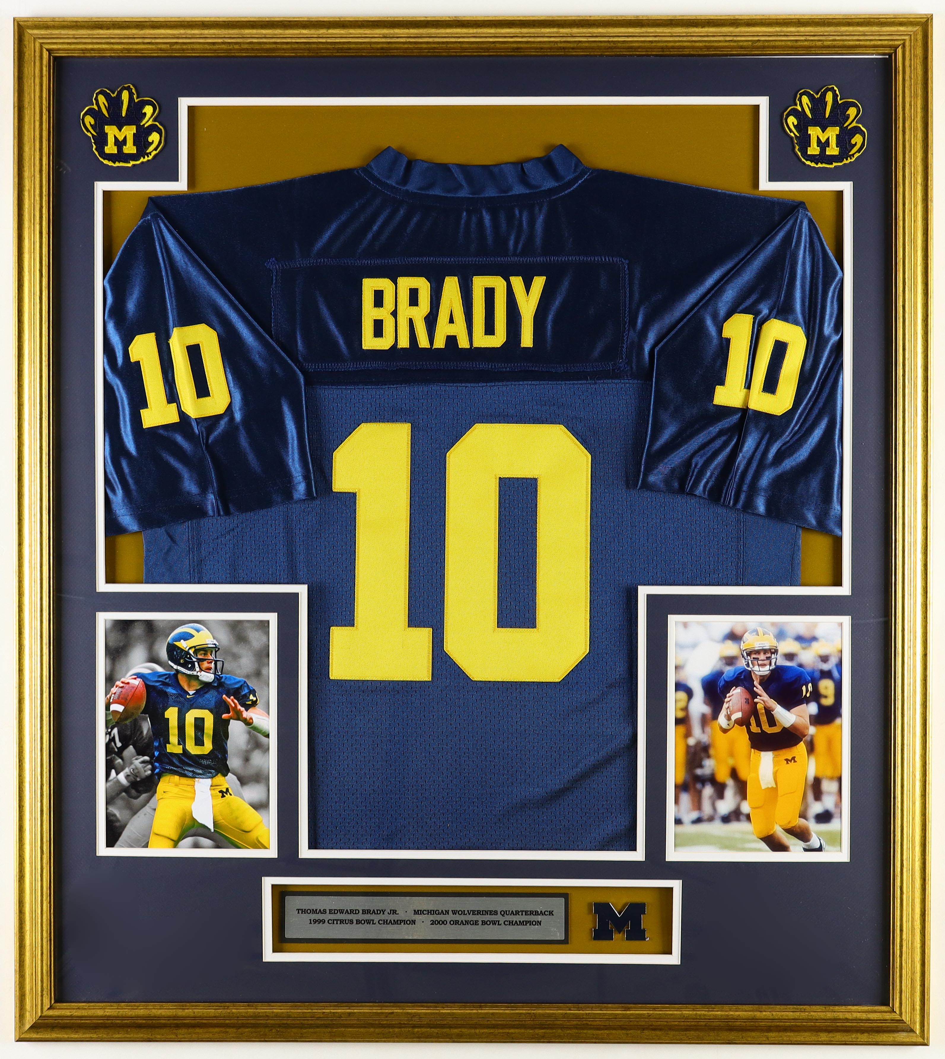 Tom Brady Custom Framed Jersey Display With Michigan Wolverines Metal Football Emblem & (2) Cloth Team Logo Patches at PristineAuction.com Tom Brady Custom Framed Jersey Display With Michigan Wolverines Metal Football Emblem & (2) Cloth Team Logo Patches at PristineAuction.com