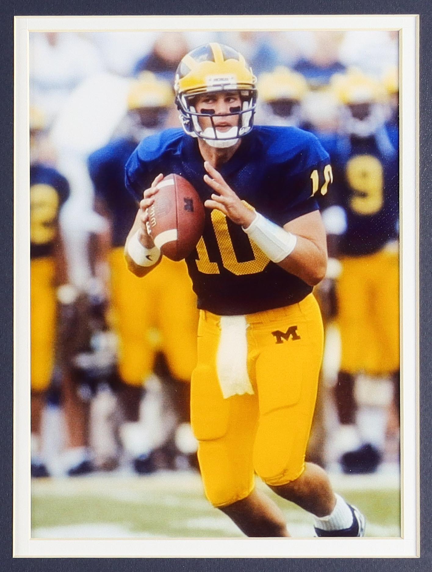 Tom Brady Custom Framed Jersey Display With Michigan Wolverines Metal Football Emblem & (2) Cloth Team Logo Patches at PristineAuction.com Tom Brady Custom Framed Jersey Display With Michigan Wolverines Metal Football Emblem & (2) Cloth Team Logo Patches at PristineAuction.com