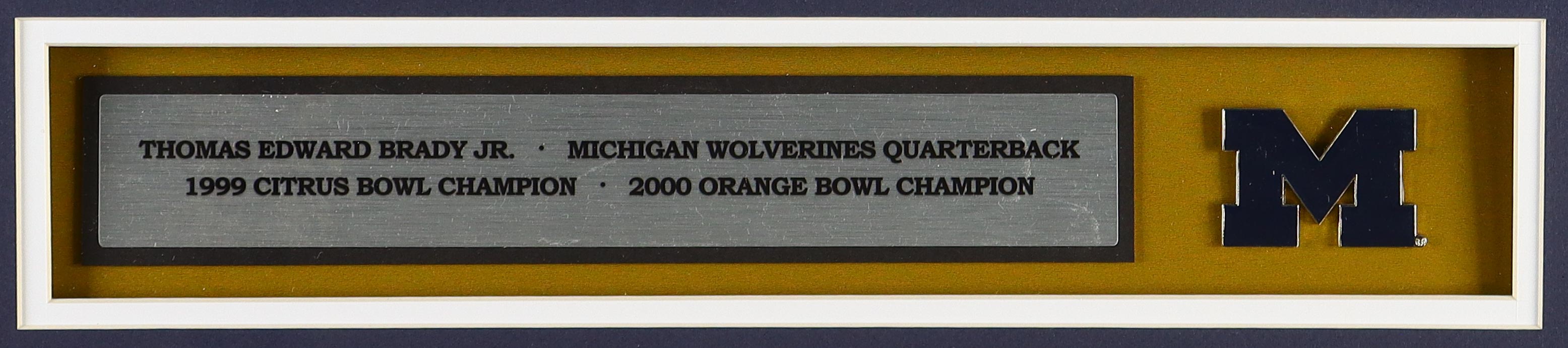 Tom Brady Custom Framed Jersey Display With Michigan Wolverines Metal Football Emblem & (2) Cloth Team Logo Patches at PristineAuction.com Tom Brady Custom Framed Jersey Display With Michigan Wolverines Metal Football Emblem & (2) Cloth Team Logo Patches at PristineAuction.com