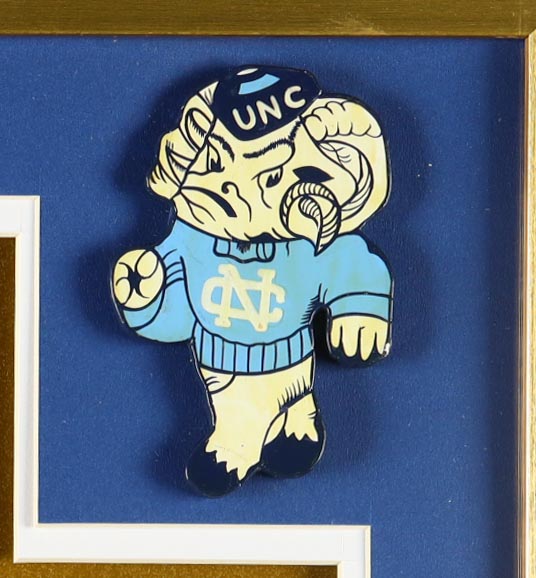 Michael Jordan Custom Framed Jersey Display With Vintage Tar Heels Pin & (2) Vintage Team Logo Ceramic Badges at PristineAuction.com Michael Jordan Custom Framed Jersey Display With Vintage Tar Heels Pin & (2) Vintage Team Logo Ceramic Badges at PristineAuction.com