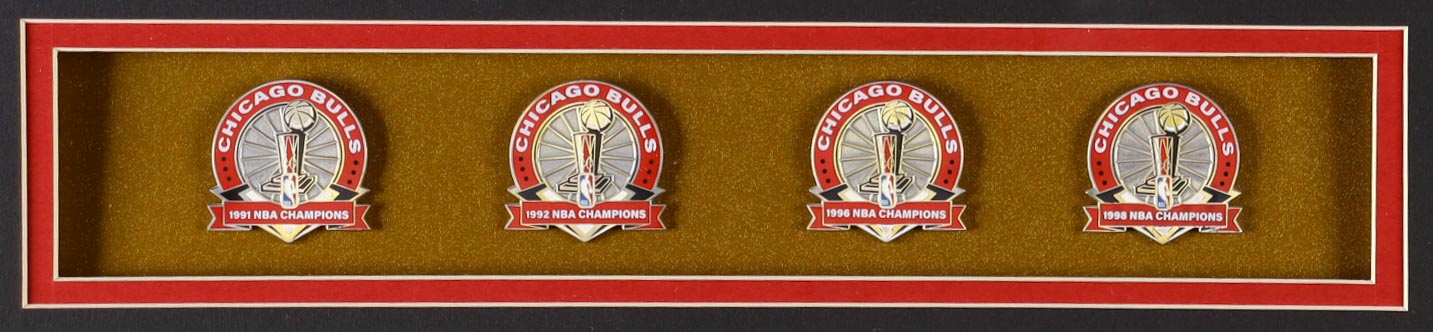 Michael Jordan Custom Framed Jersey Display with (4) LE Championship Pins & (2) Metal Team Logo Emblems at PristineAuction.com Michael Jordan Custom Framed Jersey Display with (4) LE Championship Pins & (2) Metal Team Logo Emblems at PristineAuction.com