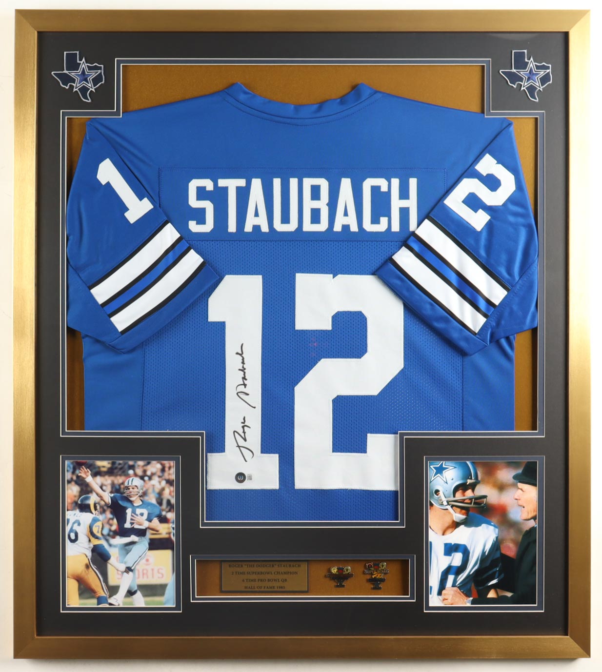 Roger Staubach Signed Custom Framed Jersey Display With (2) Official Super Bowl Pins & (2) Cloth Team Logo Patches (Beckett) at PristineAuction.com Roger Staubach Signed Custom Framed Jersey Display With (2) Official Super Bowl Pins & (2) Cloth Team Logo Patches (Beckett) at PristineAuction.com