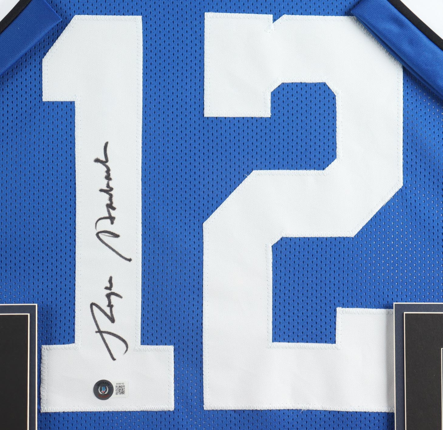 Roger Staubach Signed Custom Framed Jersey Display With (2) Official Super Bowl Pins & (2) Cloth Team Logo Patches (Beckett) at PristineAuction.com Roger Staubach Signed Custom Framed Jersey Display With (2) Official Super Bowl Pins & (2) Cloth Team Logo Patches (Beckett) at PristineAuction.com