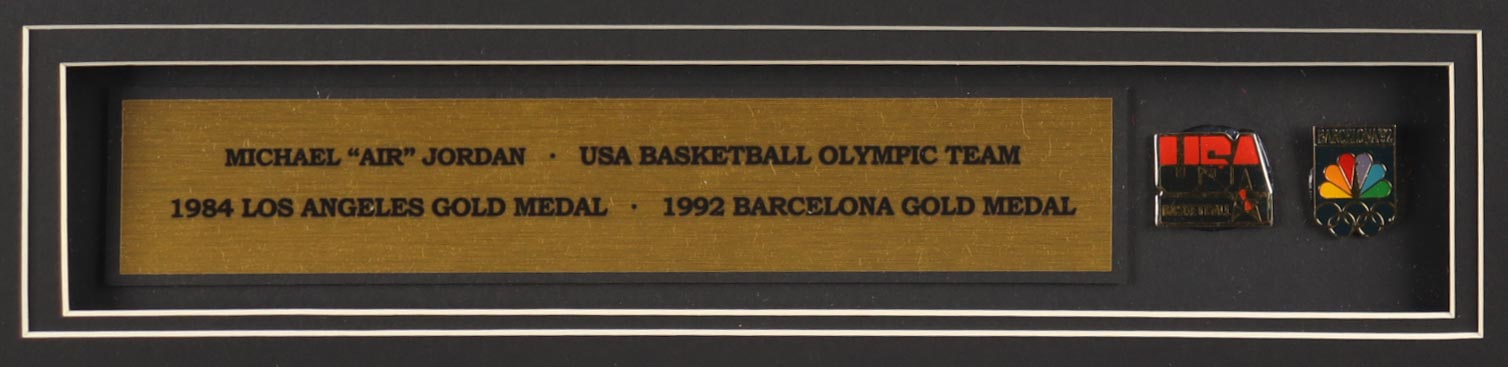 Michael Jordan Custom Framed Jersey Display with (2) Olympic Pins & Vintage USA Cloth Patch at PristineAuction.com Michael Jordan Custom Framed Jersey Display with (2) Olympic Pins & Vintage USA Cloth Patch at PristineAuction.com