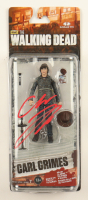 Chandler Riggs Signed "The Walking Dead" Carl Grimes Series 7 McFarlane Action Figure (JSA) at PristineAuction.com