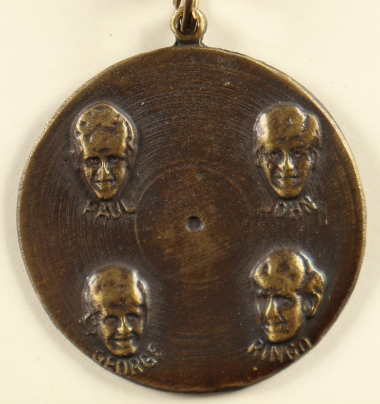 1964 The Beatles Vintage Brass Nems Keychain with Original Packaging at PristineAuction.com 1964 The Beatles Vintage Brass Nems Keychain with Original Packaging at PristineAuction.com