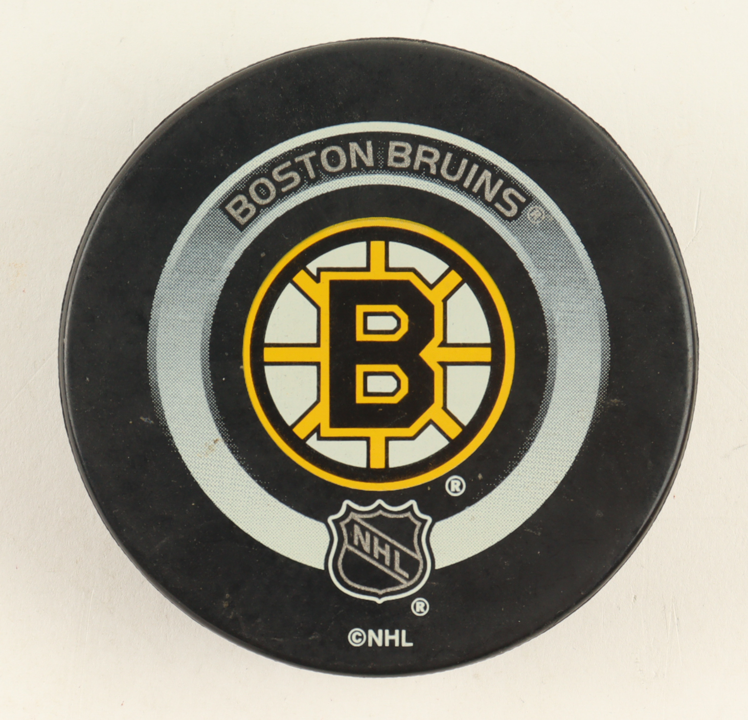 Official Game Issued Boston Bruins Logo Hockey Puck at PristineAuction.com Official Game Issued Boston Bruins Logo Hockey Puck at PristineAuction.com