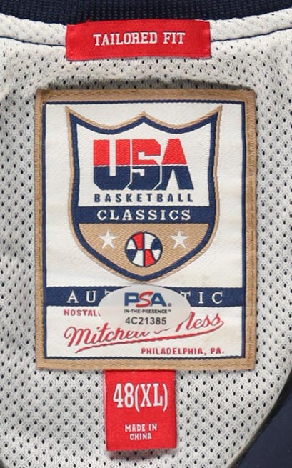 Larry Bird & Magic Johnson Signed Custom Framed Warm Up Top Display with (2) Stat Plaques & USA Patch (PSA) at PristineAuction.com Larry Bird & Magic Johnson Signed Custom Framed Warm Up Top Display with (2) Stat Plaques & USA Patch (PSA) at PristineAuction.com