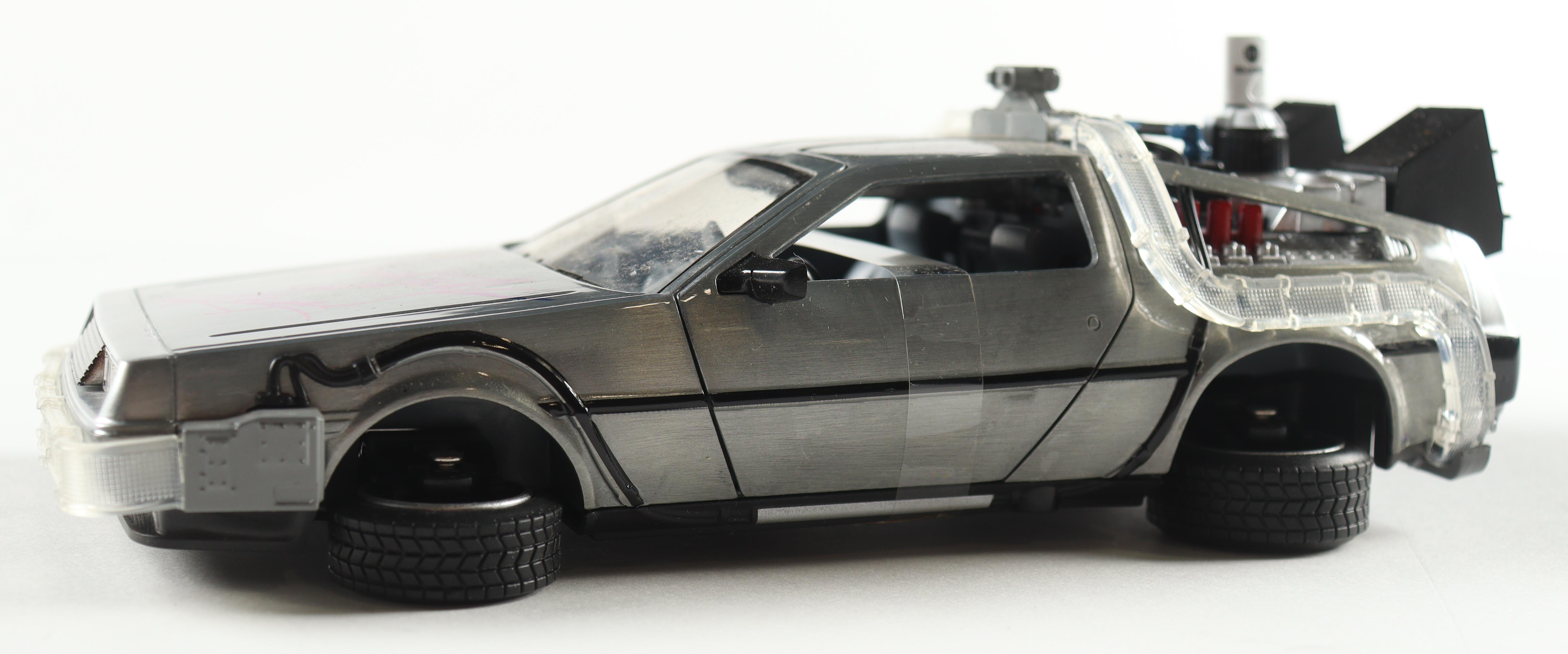 Christopher Lloyd Signed "Back to the Future" DeLorean Time Machine 1:24 Scale Die-Cast Car (Beckett) at PristineAuction.com Christopher Lloyd Signed "Back to the Future" DeLorean Time Machine 1:24 Scale Die-Cast Car (Beckett) at PristineAuction.com