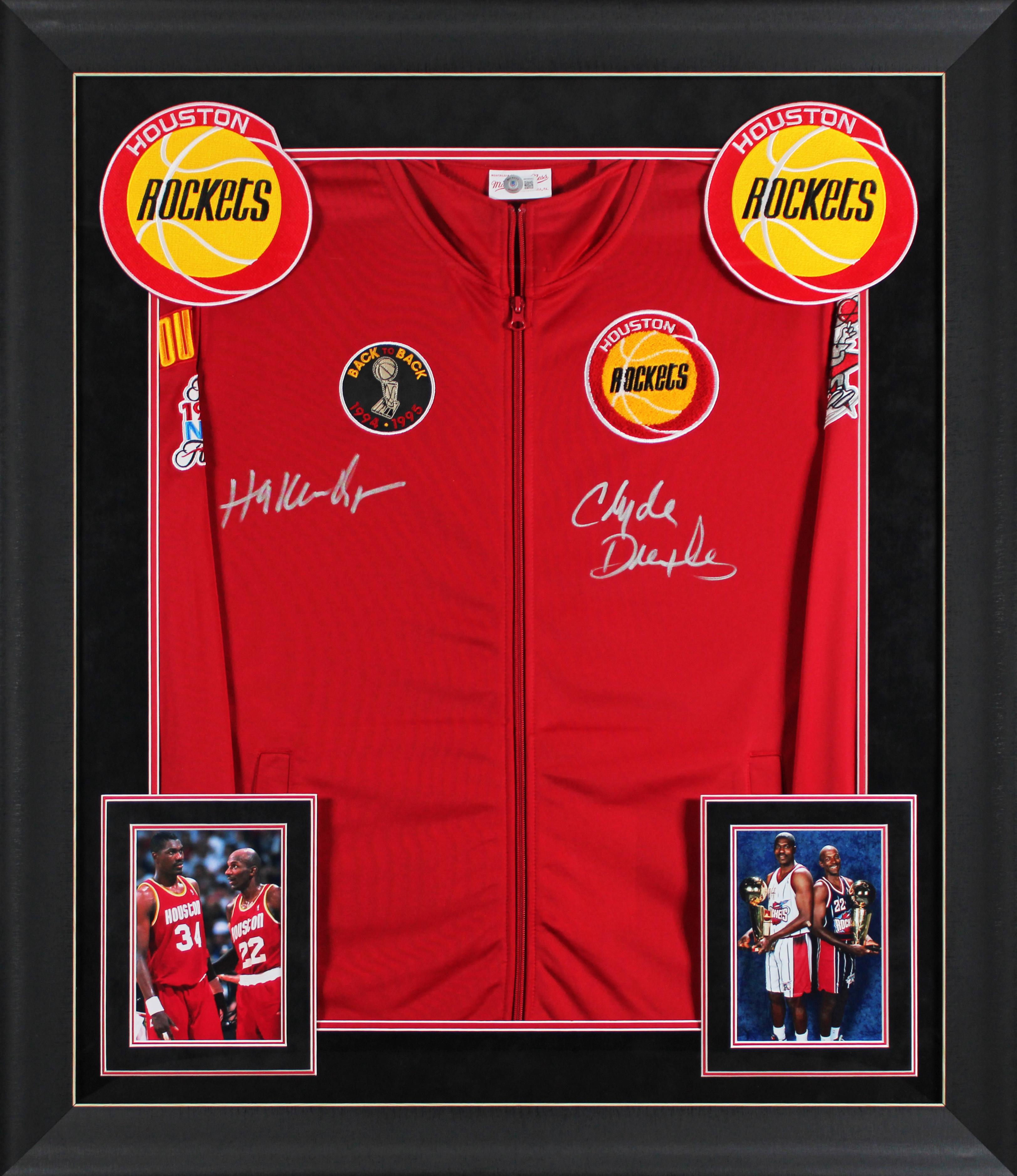 Hakeem Olajuwon & Clyde Drexler Signed Rockets Custom Framed Mitchell & Ness Bomber Jacket (Beckett) at PristineAuction.com Hakeem Olajuwon & Clyde Drexler Signed Rockets Custom Framed Mitchell & Ness Bomber Jacket (Beckett) at PristineAuction.com