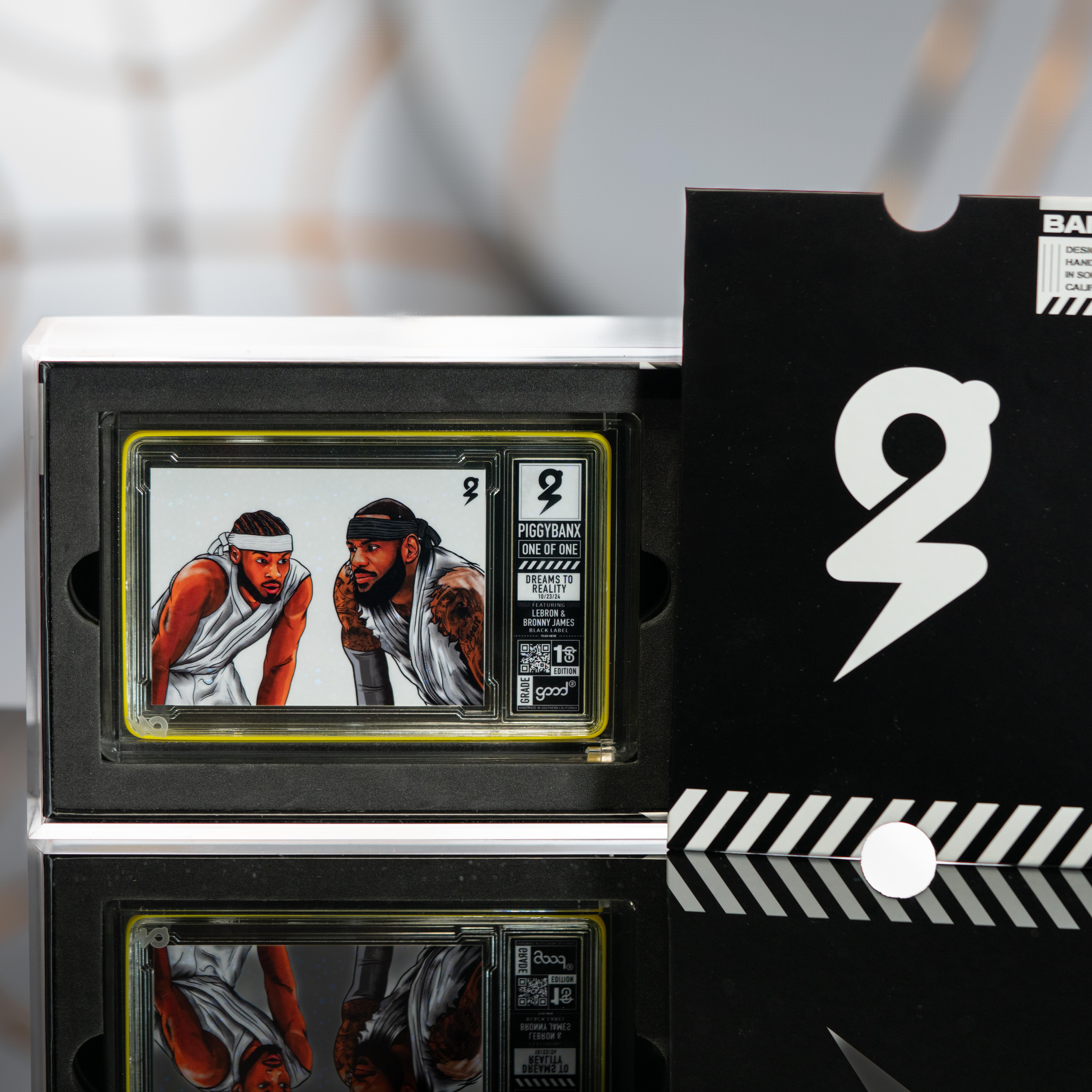 LeBron James James & Bronny James PiggyBanx "Dreams To Reality" Good 2 1st Edition Galactic Refractor #1/1 with Display Box & PiggyBanx White Gloves at PristineAuction.com LeBron James James & Bronny James PiggyBanx "Dreams To Reality" Good 2 1st Edition Galactic Refractor #1/1 with Display Box & PiggyBanx White Gloves at PristineAuction.com