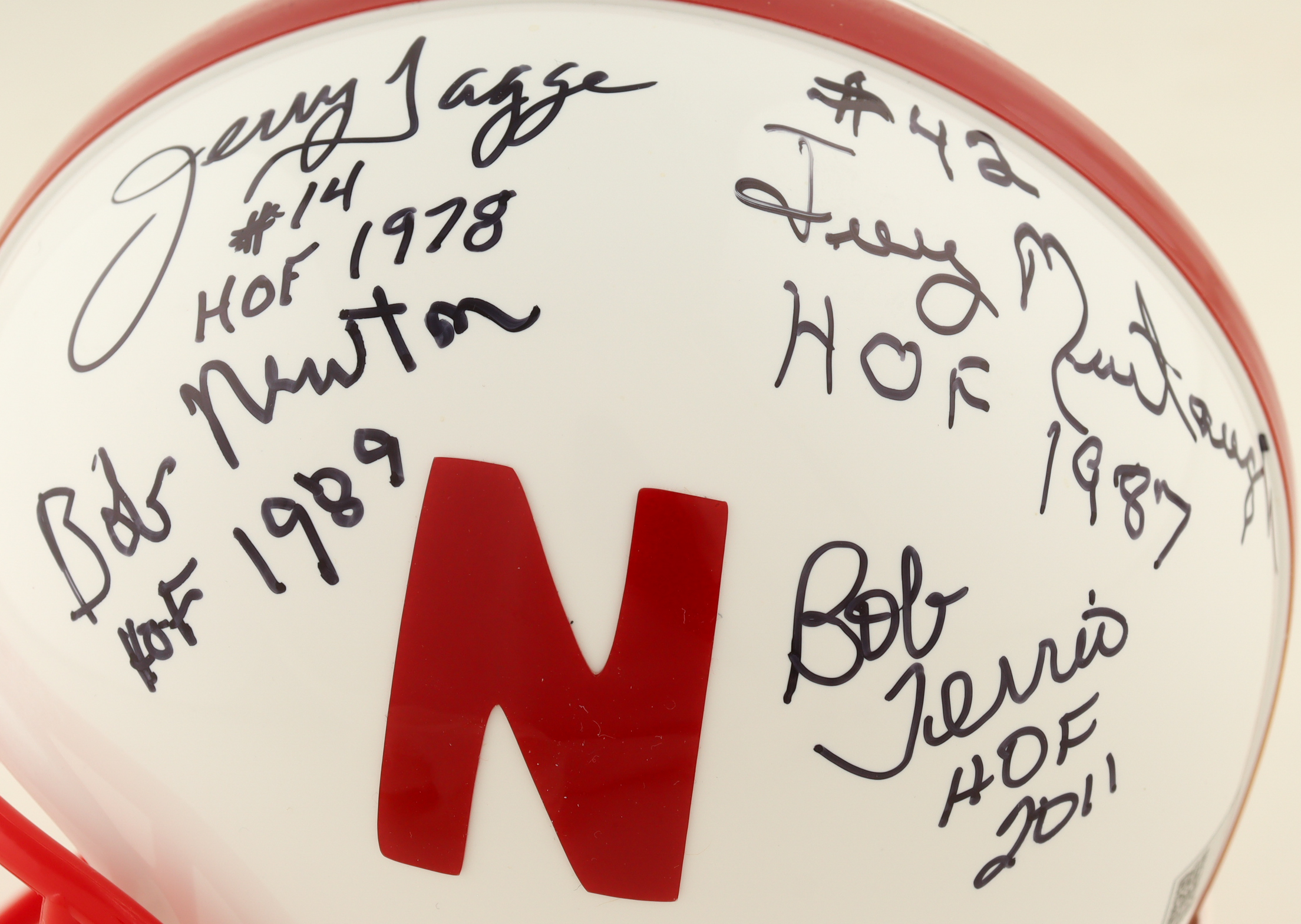 Nebraska Cornhuskers Mini Helmet Signed By (8) With Van Brownson, Dan Schneiss, Guy Ingles, Jeff Kinney With Multiple Hall Of Fame Inscriptions (AIV) at PristineAuction.com Nebraska Cornhuskers Mini Helmet Signed By (8) With Van Brownson, Dan Schneiss, Guy Ingles, Jeff Kinney With Multiple Hall Of Fame Inscriptions (AIV) at PristineAuction.com