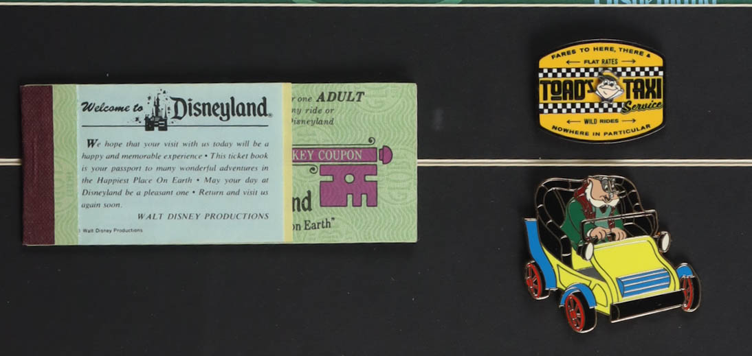 Disneyland "Mr. Toad's Wild Ride" Fantasyland Custom Framed Poster Print Display with (2) Official Ride Pin & Disneyland Ticket Book at PristineAuction.com Disneyland "Mr. Toad's Wild Ride" Fantasyland Custom Framed Poster Print Display with (2) Official Ride Pin & Disneyland Ticket Book at PristineAuction.com