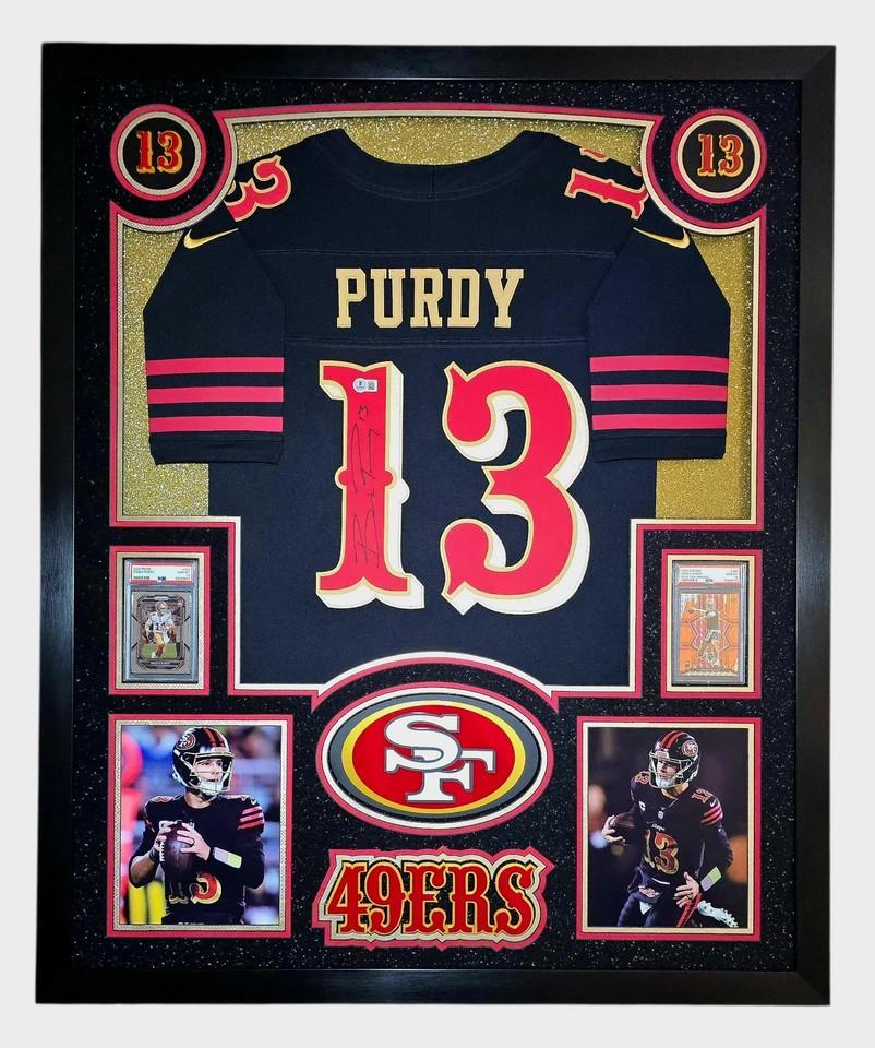 Brock Purdy Signed 49ers Custom Framed Nike Jersey with LED Display & (2) PSA 10 Graded Rookie Cards (Beckett) at PristineAuction.com Brock Purdy Signed 49ers Custom Framed Nike Jersey with LED Display & (2) PSA 10 Graded Rookie Cards (Beckett) at PristineAuction.com