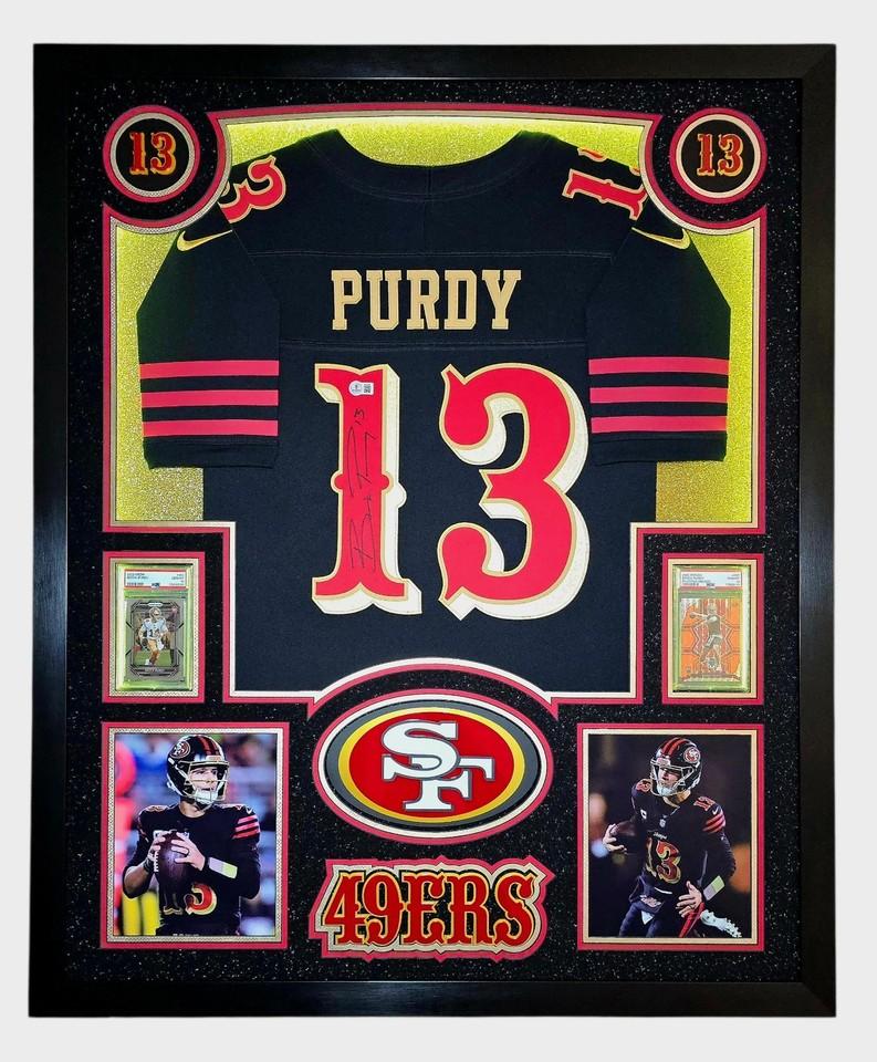 Brock Purdy Signed 49ers Custom Framed Nike Jersey with LED Display & (2) PSA 10 Graded Rookie Cards (Beckett) at PristineAuction.com Brock Purdy Signed 49ers Custom Framed Nike Jersey with LED Display & (2) PSA 10 Graded Rookie Cards (Beckett) at PristineAuction.com