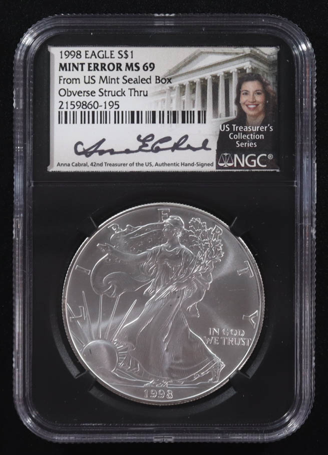 Mint Error 1998 American Silver Eagle $1 Coin Obverse Struck Thru Black Core Holder - Anna Escobedo Cabral Signed Label (NGC MS69) at PristineAuction.com Mint Error 1998 American Silver Eagle $1 Coin Obverse Struck Thru Black Core Holder - Anna Escobedo Cabral Signed Label (NGC MS69) at PristineAuction.com