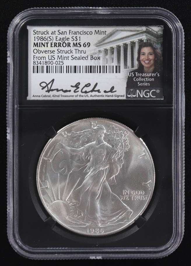 Mint Error 1986-(S) American Silver Eagle $1 Coin Struck at San Francisco Obverse Struck Thru Black Core Holder - Anna Escobedo Cabral Signed Label (NGC MS69) at PristineAuction.com Mint Error 1986-(S) American Silver Eagle $1 Coin Struck at San Francisco Obverse Struck Thru Black Core Holder - Anna Escobedo Cabral Signed Label (NGC MS69) at PristineAuction.com
