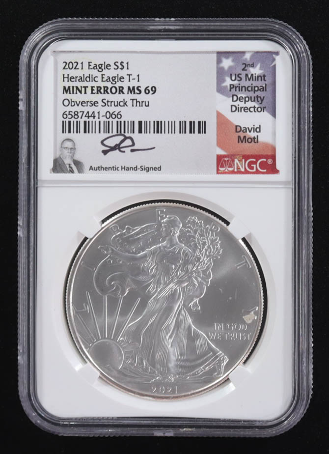 Mint Error 2021 American Silver Eagle $1 Coin Type 1 Obverse Struck Through - David Motl Signed Label (NGC MS69) at PristineAuction.com Mint Error 2021 American Silver Eagle $1 Coin Type 1 Obverse Struck Through - David Motl Signed Label (NGC MS69) at PristineAuction.com