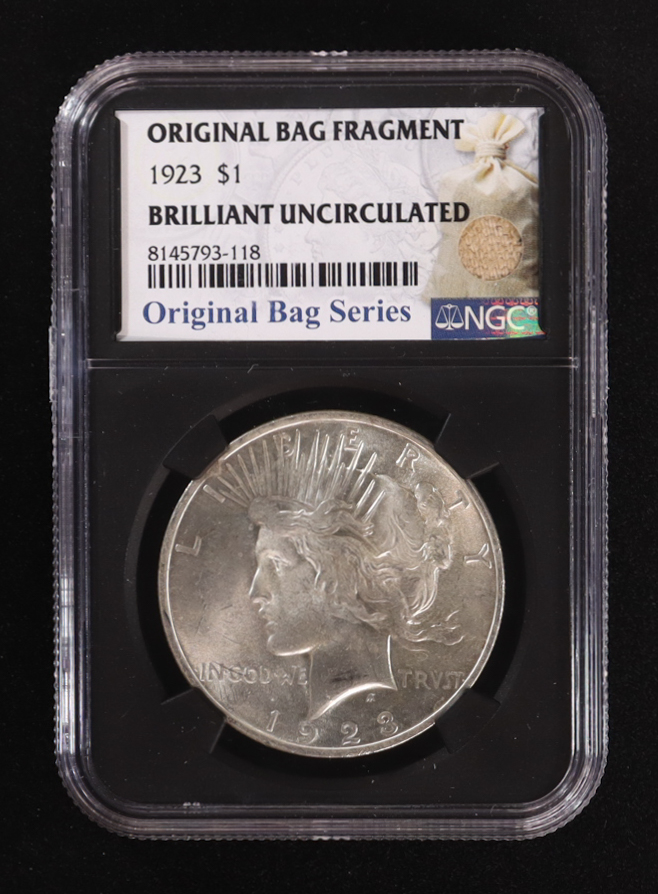 1923 Peace Silver Dollar, Original Bag Fragment Relic (NGC BRILLIANT UNCIRCULATED) - 8145793-118 at PristineAuction.com 1923 Peace Silver Dollar, Original Bag Fragment Relic (NGC BRILLIANT UNCIRCULATED) - 8145793-118 at PristineAuction.com