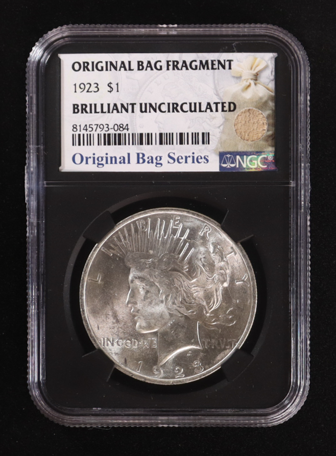 1923 Peace Silver Dollar, Original Bag Fragment Relic (NGC BRILLIANT UNCIRCULATED) - 8145793-084 at PristineAuction.com 1923 Peace Silver Dollar, Original Bag Fragment Relic (NGC BRILLIANT UNCIRCULATED) - 8145793-084 at PristineAuction.com