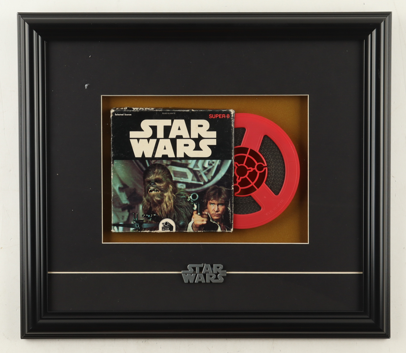 Custom Framed 1977 "STAR WARS" 8MM Film Reel in Original 20th Century Box with Pewter STAR WARS Logo at PristineAuction.com Custom Framed 1977 "STAR WARS" 8MM Film Reel in Original 20th Century Box with Pewter STAR WARS Logo at PristineAuction.com