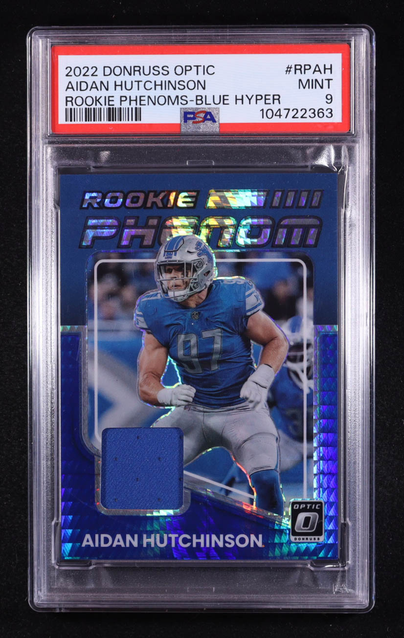 Aidan Hutchinson 2022 Donruss Optic Rookie Phenoms Jerseys Blue Hyper #13 RC (PSA 9) at PristineAuction.com Aidan Hutchinson 2022 Donruss Optic Rookie Phenoms Jerseys Blue Hyper #13 RC (PSA 9) at PristineAuction.com