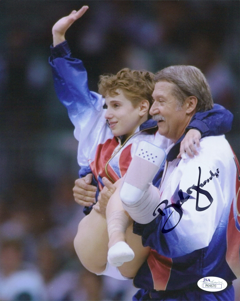 Bela Karolyi Signed Team USA 1996 Olympics 8x10 Photo with Kerri Strug (JSA COA) at PristineAuction.com Bela Karolyi Signed Team USA 1996 Olympics 8x10 Photo with Kerri Strug (JSA COA) at PristineAuction.com